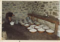 Bucchi De Giuli Assunta nella latteria di Salecchio Superiore mentre spanna il latte contenuto nelle conche